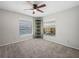 Bedroom offers neutral tones, closet, and ample natural light through multiple windows at 3002 Helms Dr, Auburndale, FL 33823