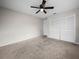 This is a bedroom featuring neutral carpet, ceiling fan and closet with bi-fold doors at 3002 Helms Dr, Auburndale, FL 33823