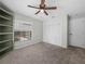 Cozy bedroom featuring carpet, ceiling fan, and large closet for storage at 3002 Helms Dr, Auburndale, FL 33823
