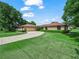 Charming brick home featuring an attached two-car garage and a well manicured front yard at 3002 Helms Dr, Auburndale, FL 33823