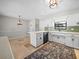 Open kitchen featuring white cabinets, stainless steel appliances, and a breakfast bar area at 3002 Helms Dr, Auburndale, FL 33823