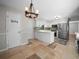 Bright kitchen featuring white cabinets, stainless steel appliances, and adjacent dining area at 3002 Helms Dr, Auburndale, FL 33823