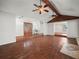 Living room with hardwood floors, vaulted ceilings, ceiling fans, and a unique entrance at 3002 Helms Dr, Auburndale, FL 33823
