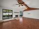 Spacious living room boasting hardwood floors, a stone fireplace, and large windows at 3002 Helms Dr, Auburndale, FL 33823