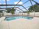 Enclosed pool area featuring clear blue water and a spacious deck at 3002 Helms Dr, Auburndale, FL 33823