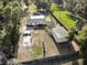 Expansive property featuring a home, outbuilding, storage structure, and fenced yard at 3233 Gardner Rd, Lakeland, FL 33810