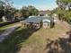 Inviting single-story home with a metal roof and a charming front porch with lovely greenery at 3233 Gardner Rd, Lakeland, FL 33810