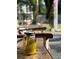 Rustic front porch decor featuring a mason jar and wooden furniture on an outdoor patio at 3233 Gardner Rd, Lakeland, FL 33810