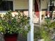 Welcoming front porch with cozy seating, plants, and a view of the red front door at 3233 Gardner Rd, Lakeland, FL 33810