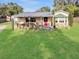 Charming home with a well-manicured lawn, inviting porch, and decorative touches enhancing curb appeal at 3233 Gardner Rd, Lakeland, FL 33810