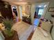 Open hallway with hardwood floors and rugs, with entry to multiple rooms and comfortable seating at 3233 Gardner Rd, Lakeland, FL 33810