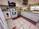 Functional kitchen equipped with white cabinets, appliances, and tile flooring at 3233 Gardner Rd, Lakeland, FL 33810