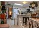 Efficient kitchen with white appliances, white cabinetry and a breakfast bar at 3233 Gardner Rd, Lakeland, FL 33810