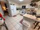 Open kitchen with white cabinets, tile floors, and view into adjacent room at 3233 Gardner Rd, Lakeland, FL 33810