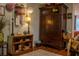 Charming living room area with hardwood floors, shelving, classic armoire and decorative lighting at 3233 Gardner Rd, Lakeland, FL 33810