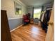 Cozy spare room with light blue paneling, guitar, desk, and a window for natural light at 3233 Gardner Rd, Lakeland, FL 33810