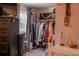 Walk-in closet featuring a rack of hanging clothing and a window at 3233 Gardner Rd, Lakeland, FL 33810