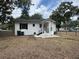 Charming single-story home featuring a backyard with patio, fenced yard, and mature trees at 375 Westover Pkwy, Bartow, FL 33830