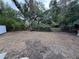 Large backyard featuring mature trees and a fenced yard at 375 Westover Pkwy, Bartow, FL 33830