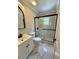 Modern bathroom featuring a glass-enclosed shower with marble tile and a sleek vanity at 375 Westover Pkwy, Bartow, FL 33830