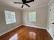 Bright bedroom with hardwood floors, natural light streaming through two windows, and a ceiling fan at 375 Westover Pkwy, Bartow, FL 33830