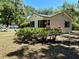 Charming home featuring a quaint exterior, complemented by lush greenery and landscaping at 375 Westover Pkwy, Bartow, FL 33830