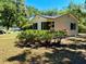 Charming home featuring a quaint exterior, complemented by lush greenery and landscaping at 375 Westover Pkwy, Bartow, FL 33830