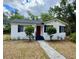 Charming single story home with a red front door, black shutters, and manicured front yard at 375 Westover Pkwy, Bartow, FL 33830