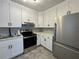 Modern kitchen with white cabinets, stainless steel appliances, tile backsplash, and solid surface countertops at 375 Westover Pkwy, Bartow, FL 33830