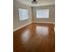 Bright living room featuring hardwood floors, neutral paint, and natural light from the windows at 375 Westover Pkwy, Bartow, FL 33830
