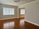 Bright living room featuring hardwood floors, neutral paint, and natural light from the windows at 375 Westover Pkwy, Bartow, FL 33830