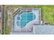 Aerial view of a private screened pool and spa in a lush backyard setting at 3822 Marquise Ln, Mulberry, FL 33860
