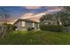 Well-maintained backyard with lush lawn, landscaping, and partial view of screened pool at 3822 Marquise Ln, Mulberry, FL 33860