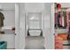 Hallway view into bathroom with freestanding tub and and walk-in closets at 3822 Marquise Ln, Mulberry, FL 33860
