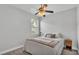 A cozy bedroom features a bed, a ceiling fan, and a window at 3822 Marquise Ln, Mulberry, FL 33860