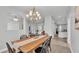 Bright dining room with a chandelier, wood table set, and access to the living spaces at 3822 Marquise Ln, Mulberry, FL 33860
