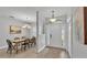 Inviting entryway with dining area featuring modern chandelier and wood-look tile flooring at 3822 Marquise Ln, Mulberry, FL 33860