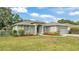 Charming single-story home featuring a well-maintained lawn, lush landscaping, and an attached garage at 3822 Marquise Ln, Mulberry, FL 33860