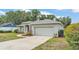 Well-maintained home with an attached garage and manicured landscaping in a quiet neighborhood at 3822 Marquise Ln, Mulberry, FL 33860