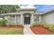Inviting front entrance with a beautifully landscaped walkway leading to a welcoming front door at 3822 Marquise Ln, Mulberry, FL 33860