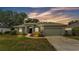 Charming home with an attached garage, manicured lawn, and a walkway to the front door at 3822 Marquise Ln, Mulberry, FL 33860