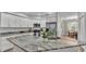 Bright kitchen featuring stainless steel appliances, granite countertops, and ample cabinet space at 3822 Marquise Ln, Mulberry, FL 33860