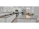 Kitchen island featuring granite countertops, white cabinetry and stainless steel appliances at 3822 Marquise Ln, Mulberry, FL 33860