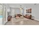 Cozy living room with leather sofas, stylish rug, and access to the pool area at 3822 Marquise Ln, Mulberry, FL 33860