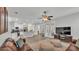 Spacious living room open to the kitchen with modern ceiling fan and access to the back patio at 3822 Marquise Ln, Mulberry, FL 33860