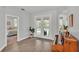 Living room with wood-look tile floors and glass doors leading to the pool at 3822 Marquise Ln, Mulberry, FL 33860