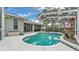 Serene screened pool and spa surrounded by a spacious patio and beautiful landscaping for relaxation at 3822 Marquise Ln, Mulberry, FL 33860