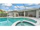 A backyard oasis with a screened pool, spa, and covered patio, ideal for outdoor living at 3822 Marquise Ln, Mulberry, FL 33860