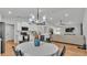 Open-concept dining and living area with wood floors and modern lighting at 3946 Willow Ridge Dr, Lakeland, FL 33810