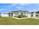 Charming single-Gathering home featuring a well-manicured lawn, a two-car garage, and complemented by lush landscaping at 3946 Willow Ridge Dr, Lakeland, FL 33810